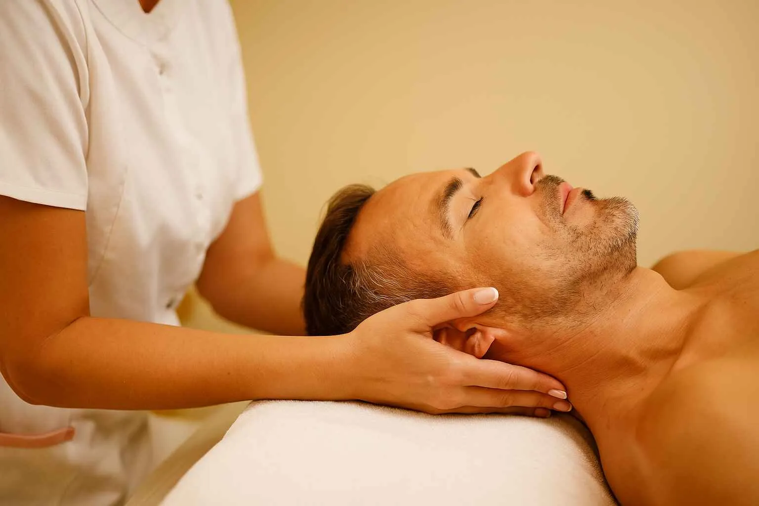 man leaning back and massaging his neck