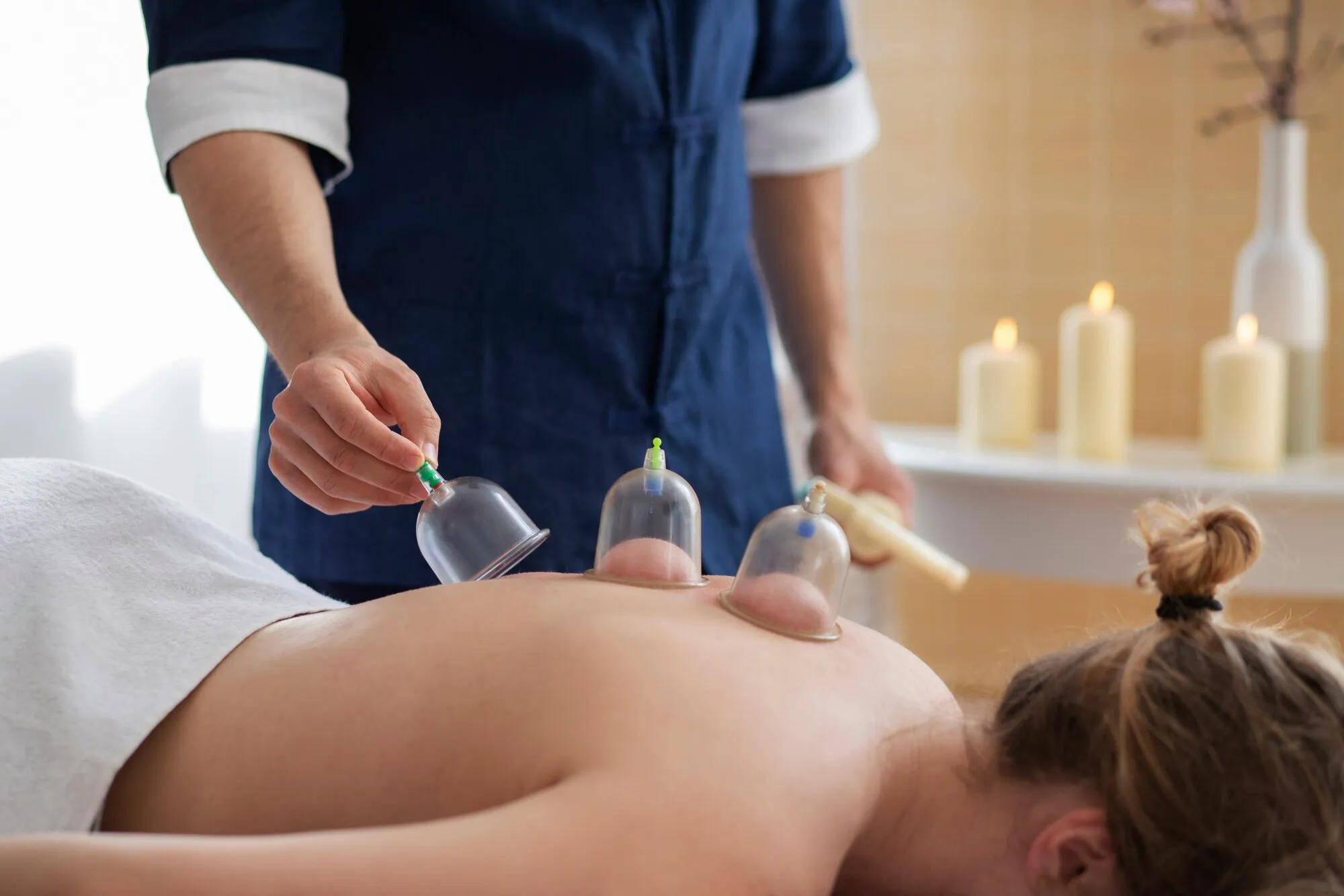 lady leaning on her back exposed with cup , currently in cup massage session